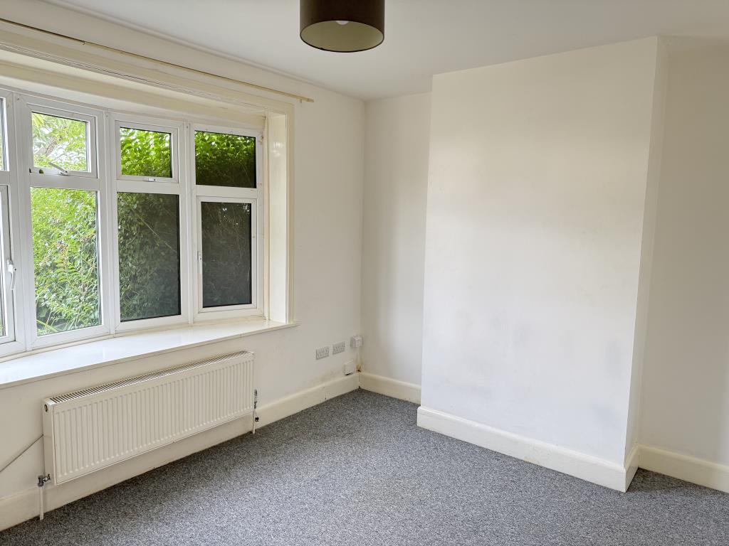 Lot: 124 - THREE-BEDROOM SEMI-DETACHED HOUSE - Living room with white walls and bay window
